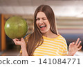 Young woman with ball in bowling club Young woman with ball in bowling club 141084771
