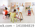 Cute little children painting during lesson in room Cute little children painting during lesson in room 141084819