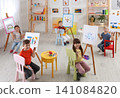 Cute little children painting during lesson in room Cute little children painting during lesson in room 141084820