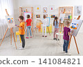Cute little children painting during lesson in room Cute little children painting during lesson in room 141084821