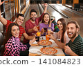 Group of friends with drinks and pizza in bowling club Group of friends with drinks and pizza in bowling club 141084823