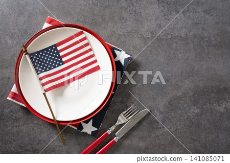 American flag on white plate with patriotic table setting American flag on white plate with patriotic table setting 141085071