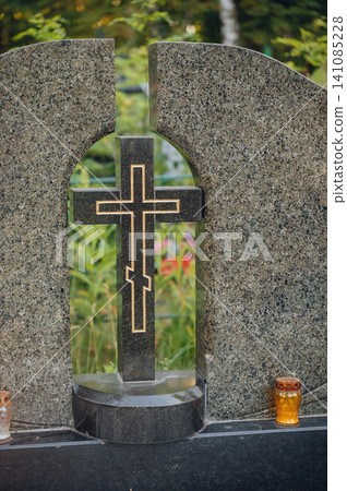 serene grave marker with cross in cemetery side view with lanterns and granite material, black and gold colors, still life scene, editorial use case, memorial setting. serene grave marker with cross in cemetery side view with lanterns and granite material, black and gold colors, still life scene, editorial use case, memorial setting. 141085228