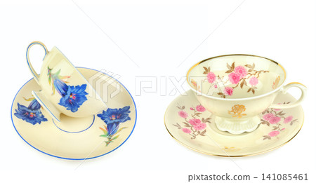 Vintage Porcelain Teacups and Saucers with Floral Ornaments Isolated on White Vintage Porcelain Teacups and Saucers with Floral Ornaments Isolated on White 141085461