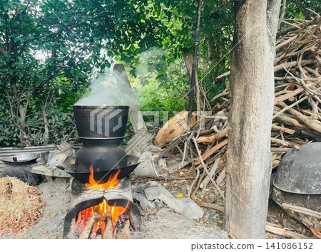 Traditional Thai Wood Burning Stove for Steaming Sticky Rice Outdoors Traditional Thai Wood Burning Stove for Steaming Sticky Rice Outdoors 141086152