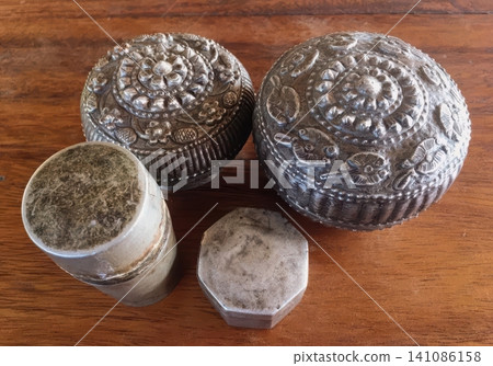Antique Thai Silver Containers on Rustic Wooden Background Antique Thai Silver Containers on Rustic Wooden Background 141086158