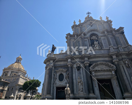 CATANIA Baroque Cathedral Facade With Statues, Dome and Columns Under Clear Blue Sky CATANIA Baroque Cathedral Facade With Statues, Dome and Columns Under Clear Blue Sky 141086596