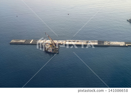 genoa new dam seawall construction aerial view while landing to airport genoa new dam seawall construction aerial view while landing to airport 141086658