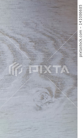 Whitewashed wooden board with distressed finish, showing light gray and off white grain with a prominent knot pattern. Whitewashed wooden board with distressed finish, showing light gray and off white grain with a prominent knot pattern. 141086685