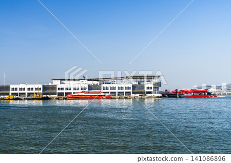 View of the Outer Harbour Ferry Terminal building in Macau, China. It provides ferry services to Hong Kong. View of the Outer Harbour Ferry Terminal building in Macau, China. It provides ferry services to Hong Kong. 141086896