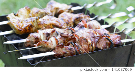 Grilling delicious shashlik on mangal during backyard gathering in warm weather Grilling delicious shashlik on mangal during backyard gathering in warm weather 141087009