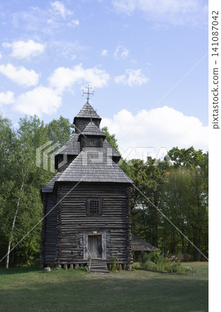 Wooden peasant church from the medieval period set among trees under a clear blue sky Wooden peasant church from the medieval period set among trees under a clear blue sky 141087042