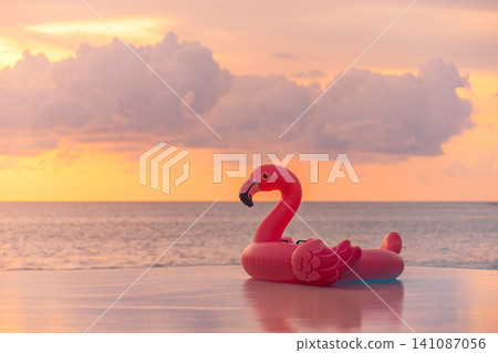 Fun pink flamingo float, dreamy pastel sunset, calm tropical sea. Playful summer beach vacation, romantic holiday getaway. Trendy relaxing wallpaper, soft sunset pool party scene Fun pink flamingo float, dreamy pastel sunset, calm tropical sea. Playful summer beach vacation, romantic holiday getaway. Trendy relaxing wallpaper, soft sunset pool party scene 141087056