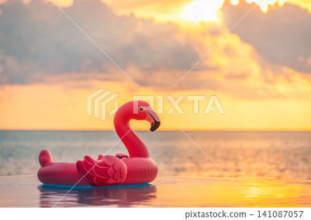 Playful pink flamingo float, warm golden sunset, glowing tropical sea. Fun summer beach vacation, dreamy holiday getaway. Trendy relaxing wallpaper, romantic sunset pool party scene 141087057