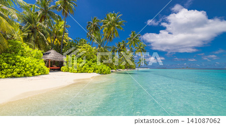 Idyllic tropical beach, palm trees, turquoise lagoon, lush green island. Sunny summer white sand paradise, exotic vacation escape. Relaxing travel destination background wallpaper scene Idyllic tropical beach, palm trees, turquoise lagoon, lush green island. Sunny summer white sand paradise, exotic vacation escape. Relaxing travel destination background wallpaper scene 141087062