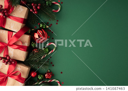 Christmas holiday gifts and ornaments on green background Christmas holiday gifts and ornaments on green background 141087463