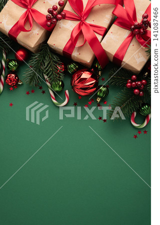 Christmas gifts and decorations on green background Christmas gifts and decorations on green background 141087466
