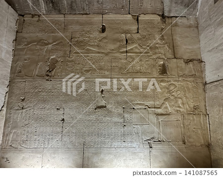 Beautiful bas-reliefs and ancient hieroglyphs in the Temple of Seti I in Abydos, Egypt. 141087565