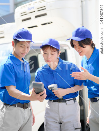 Delivery staff checking the vehicle in coordination with each other. Delivery staff checking the vehicle in coordination with each other. 141087845