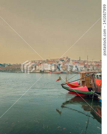 Traditional Rabelo boats, once used to transport port wine along the Douro River, now symbolize Portugal s rich winemaking heritage. Traditional Rabelo boats, once used to transport port wine along the Douro River, now symbolize Portugal s rich winemaking heritage. 141087999