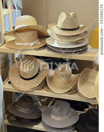 Hats displayed on wooden shelves in a store as a stylish fashion accessory background Hats displayed on wooden shelves in a store as a stylish fashion accessory background 141088174