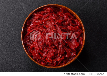 Grated beetroot with salt and spices as an ingredient for borscht or a vegan salad. Grated beetroot 141088264