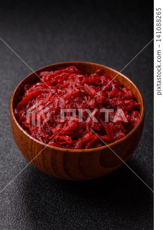 Grated beetroot with salt and spices as an ingredient for borscht or a vegan salad. Grated beetroot 141088265