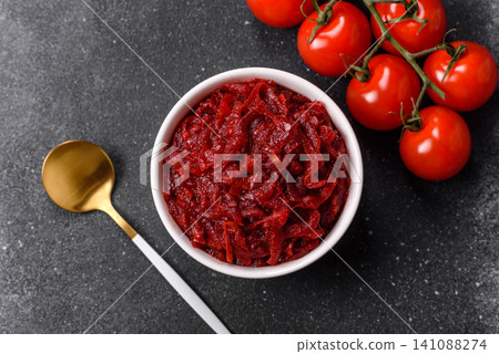 Grated beetroot with salt and spices as an ingredient for borscht or a vegan salad. Grated beetroot Grated beetroot with salt and spices as an ingredient for borscht or a vegan salad. Grated beetroot 141088274