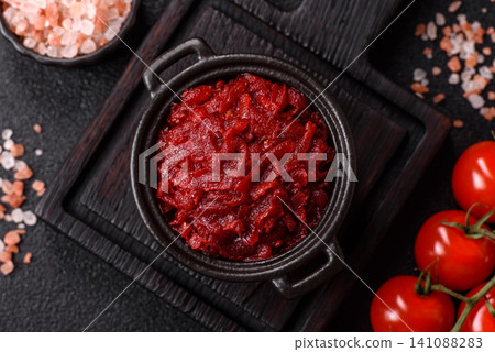 Grated beetroot with salt and spices as an ingredient for borscht or a vegan salad. Grated beetroot 141088283