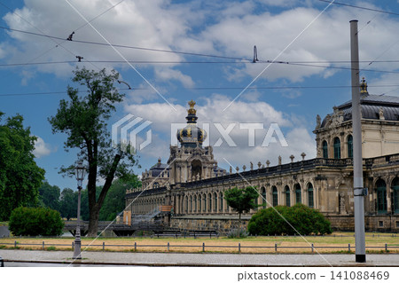 Magnificent baroque palace with ornate crown pavilion and large courtyard under beautiful dramatic cloudy sky Magnificent baroque palace with ornate crown pavilion and large courtyard under beautiful dramatic cloudy sky 141088469