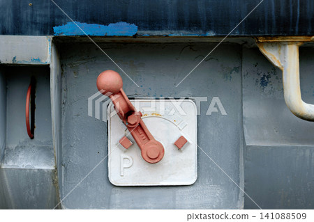 Vintage red mechanical parking brake lever on industrial railway wagon panel Vintage red mechanical parking brake lever on industrial railway wagon panel 141088509