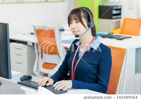 Image of a female call center operator Image of a female call center operator 141089564