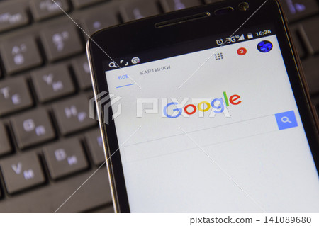 Smartphone with Google search system on the keyboard background. Smartphone with Google search system on the keyboard background. 141089680