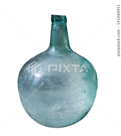 A vintage large glass bottle stands alone on a white background, showcasing its clear turquoise color and round shape. This item can be used for home decor or winemaking. A vintage large glass bottle stands alone on a white background, showcasing its clear turquoise color and round shape. This item can be used for home decor or winemaking. 141089951
