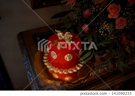 Red velvet cake with golden lion and coin decorations Red velvet cake with golden lion and coin decorations 141090235