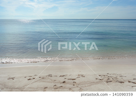 Calm tropical beach with footprints in white sand Calm tropical beach with footprints in white sand 141090359