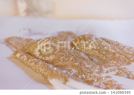 Golden embroidered fabric with sequin details Golden embroidered fabric with sequin details 141090395