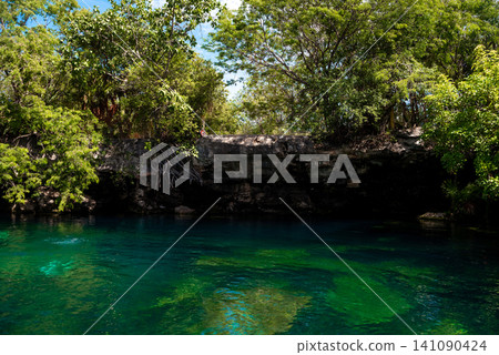 Cenote with turquoise water and rocky cliff Cenote with turquoise water and rocky cliff 141090424