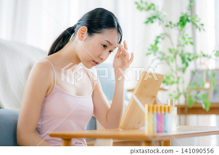 A young woman suffering from skin problems A young woman suffering from skin problems 141090556