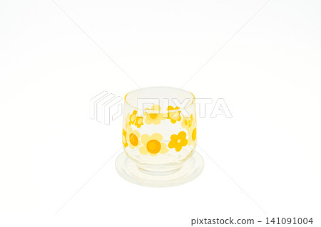 A retro-style yellow and orange cup with a pop floral pattern. A retro-style yellow and orange cup with a pop floral pattern. 141091004