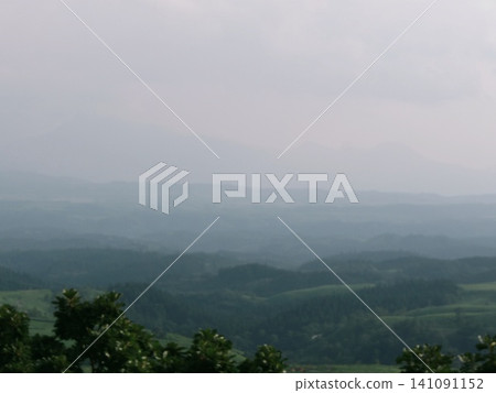 The mountain range of Kuju Plateau shrouded in mist and the scenery of fresh greenery. The mountain range of Kuju Plateau shrouded in mist and the scenery of fresh greenery. 141091152