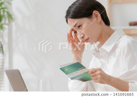A woman who falls down looking at a passbook A woman who falls down looking at a passbook 141091665