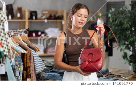 Woman choosing handbags in the store 141091770