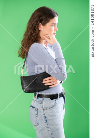 Young woman sad and upset in front of green screen Young woman sad and upset in front of green screen 141091873