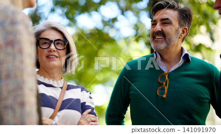 Smiling people enjoying outdoor conversation and interaction 141091970
