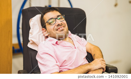 Young man with disability smiling in wheelchair Young man with disability smiling in wheelchair 141092001