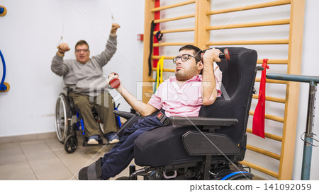 Wheelchair users exercising during rehabilitation therapy Wheelchair users exercising during rehabilitation therapy 141092059