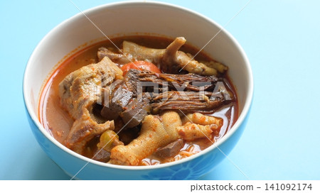 rice vermicelli with northern thai curry sauce on blue background rice vermicelli with northern thai curry sauce on blue background 141092174