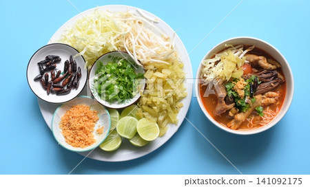 rice vermicelli with northern thai curry sauce on blue background rice vermicelli with northern thai curry sauce on blue background 141092175