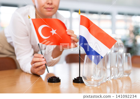 Blurry girl set midget flags of Netherlands and Turkey before international negotiations Blurry girl set midget flags of Netherlands and Turkey before international negotiations 141092234